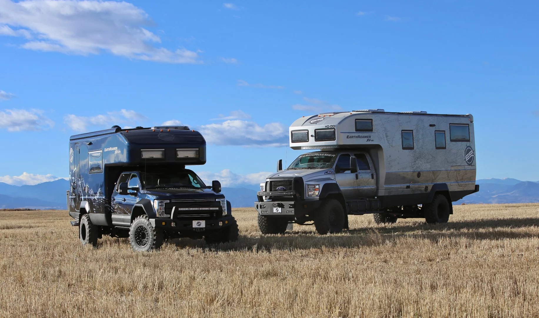 The EarthRoamer XV-LTS (left) is traditionally one of the larger exhibitor vehicles on display at Overland Expo West, but it looks rather compact in this photo