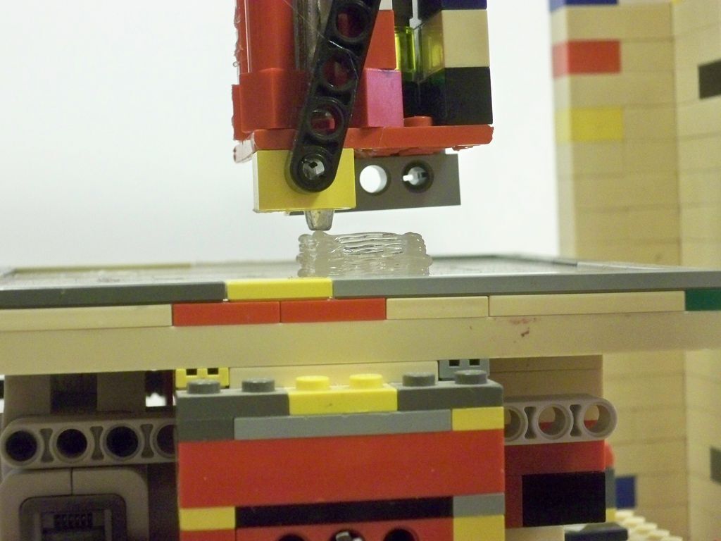 The LEGObot prints with hot glue and utilizes a hot glue gun as an extruder