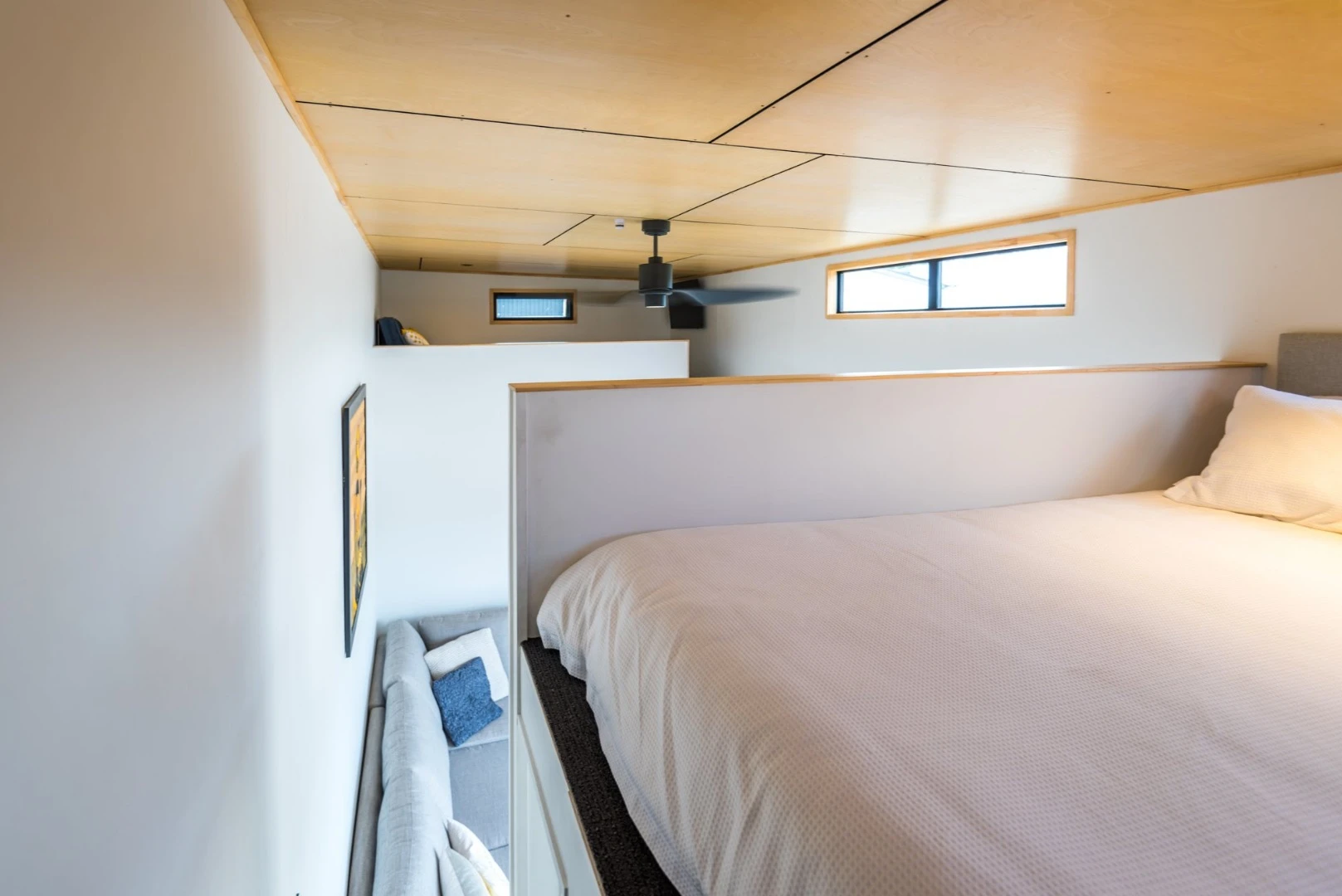Themaster mezzanine featuresa queen size bed and easy access stairs