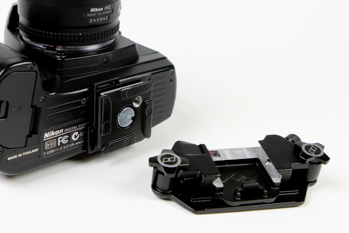 The connection plate is attached to the bottom of the DSLR camera via a screw into the tripod mount