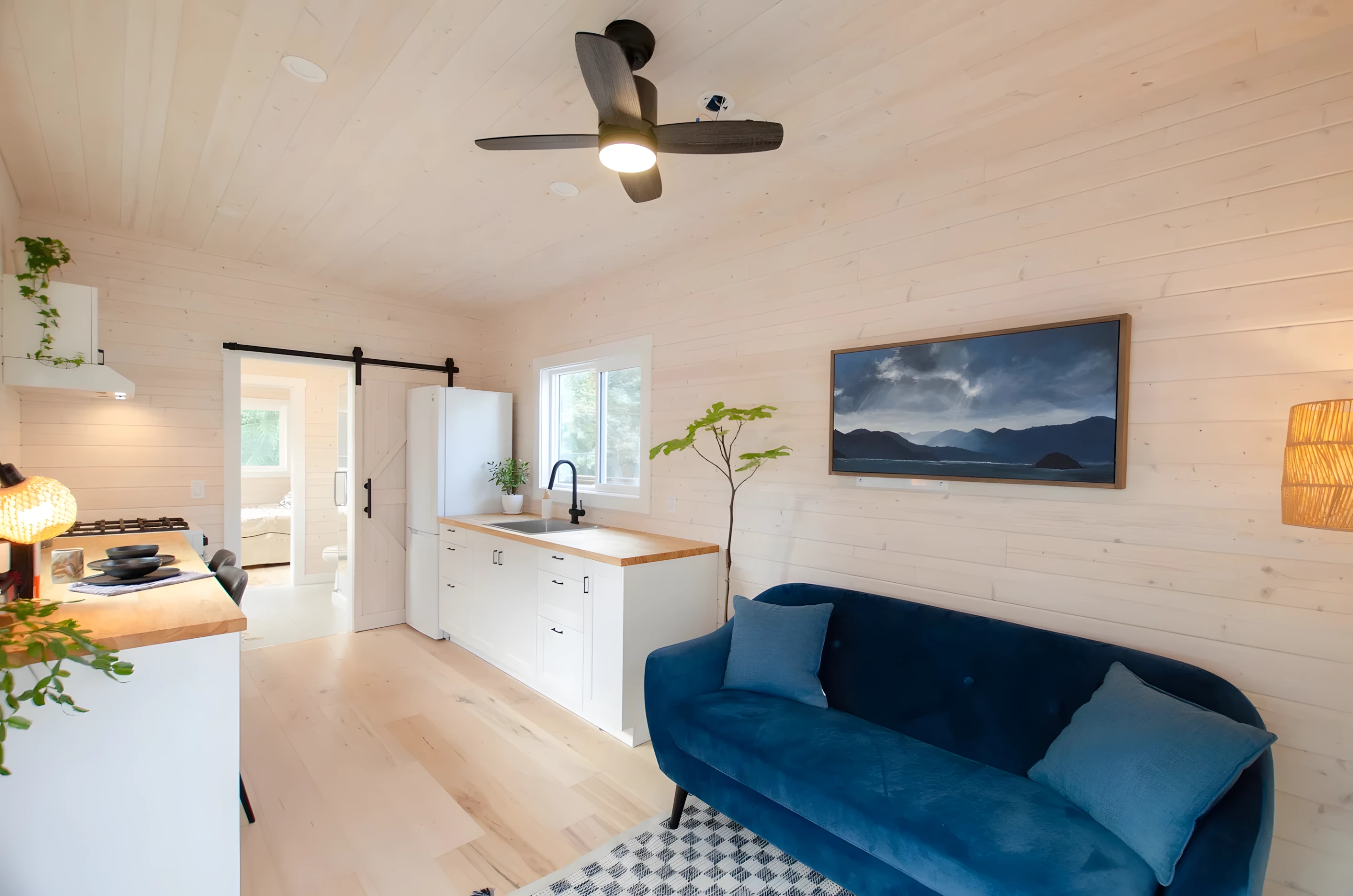 The Barred Owl's entrance opens into a bright living room finished in whitewashed pine tongue-and-groove

