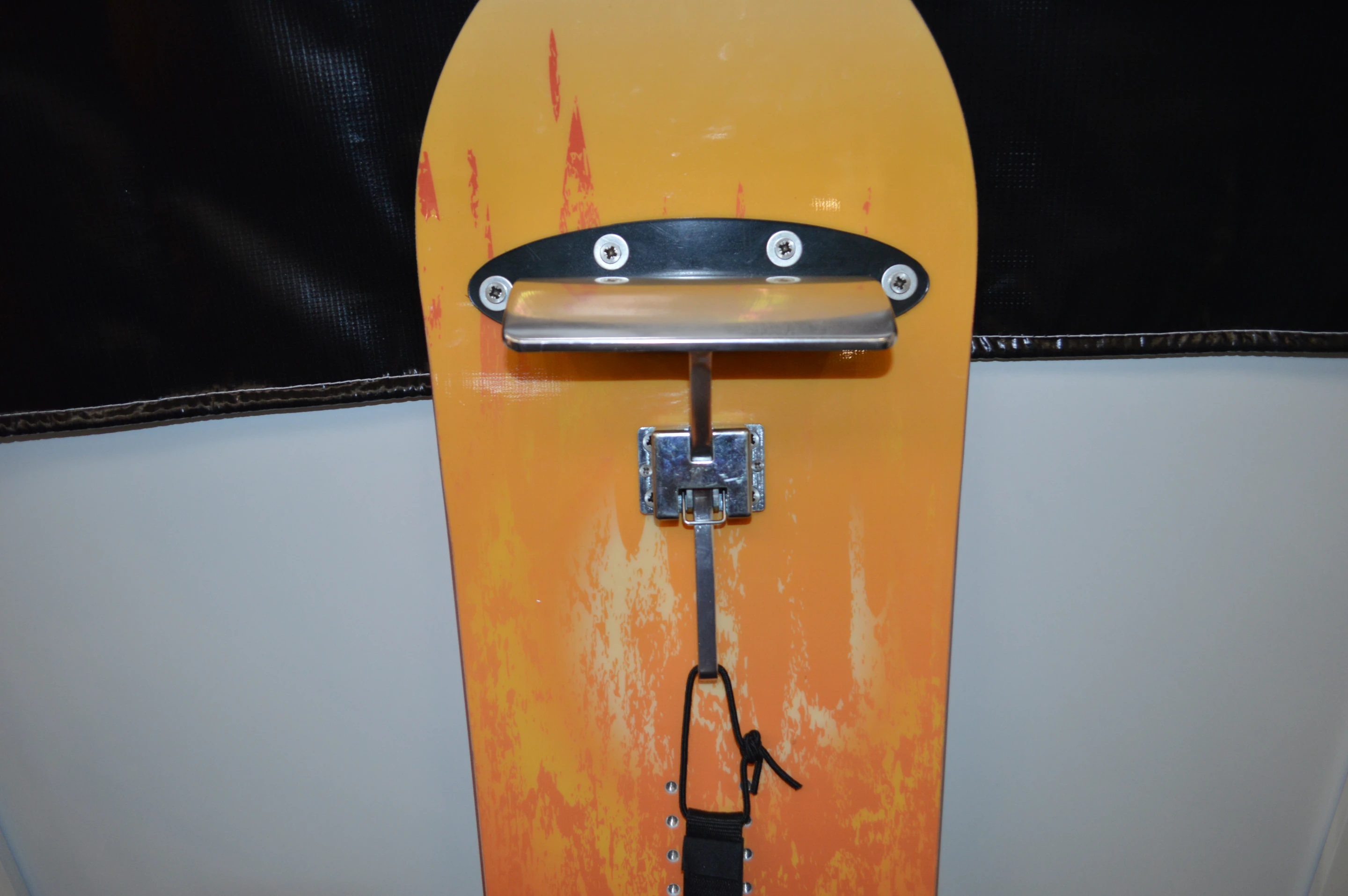 The curved braking blade slows the board to a stop