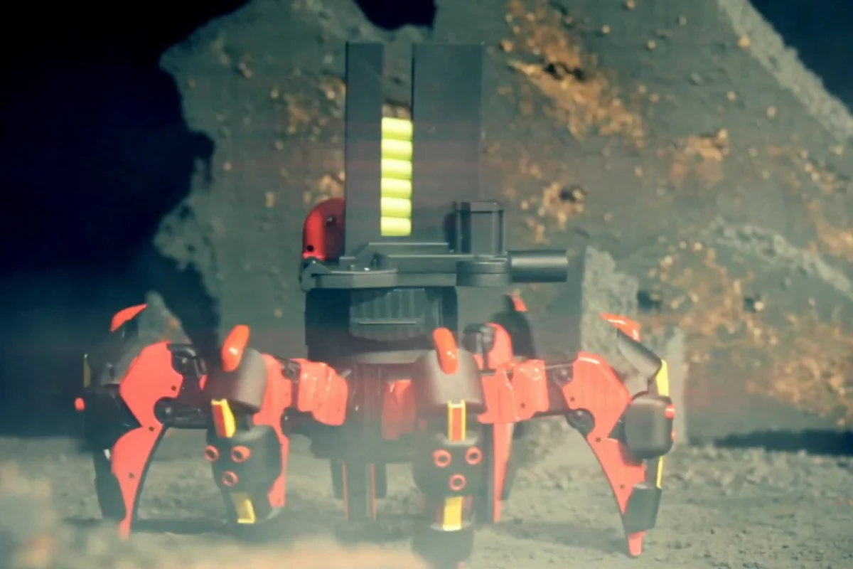 The toy robot's launchers can be aimed by remotely tilting it and shoots farther when the fire button is held down longer