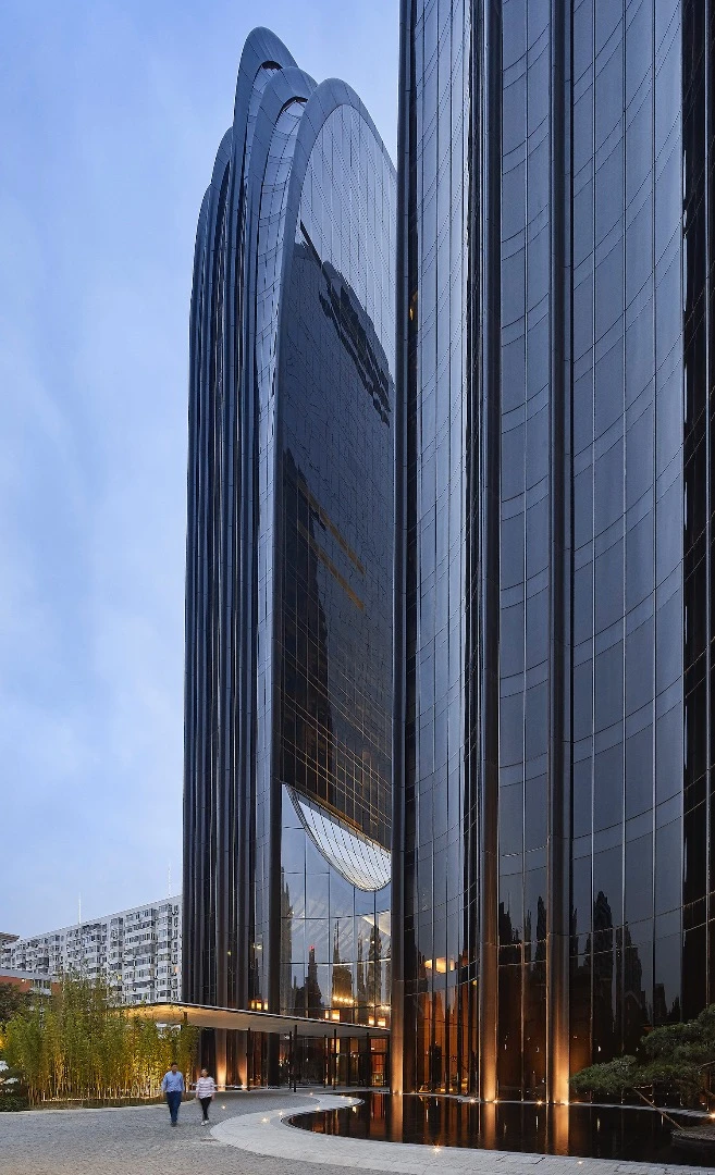 Rising to a height of 142 m (465 ft)-tall, the Chaoyang Park Plaza's towers have a remarkable design that's reminiscent of a couple of massive mountain peaks
