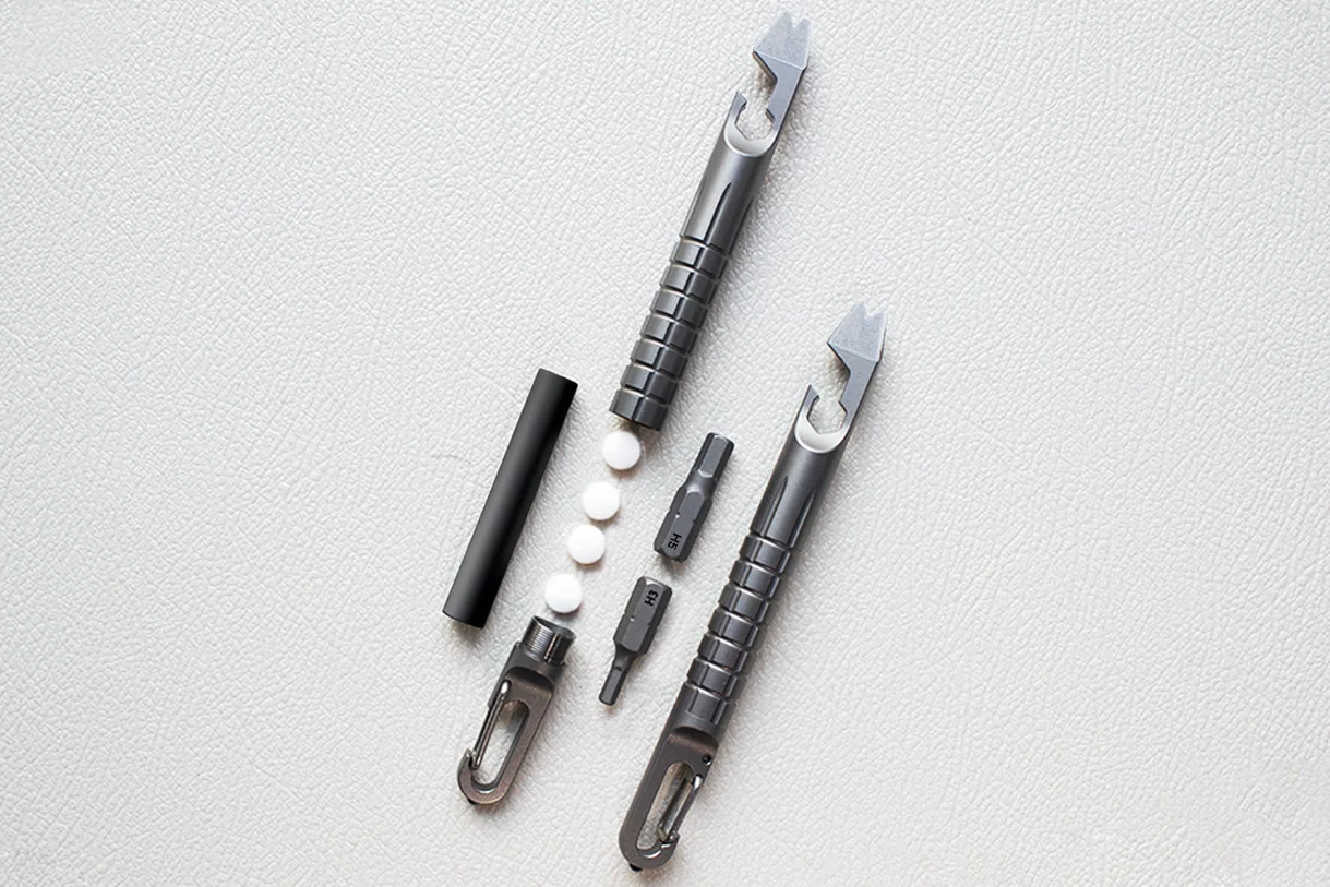 The Infinity can carry its included ferro rod (left) or items such as pills and bits