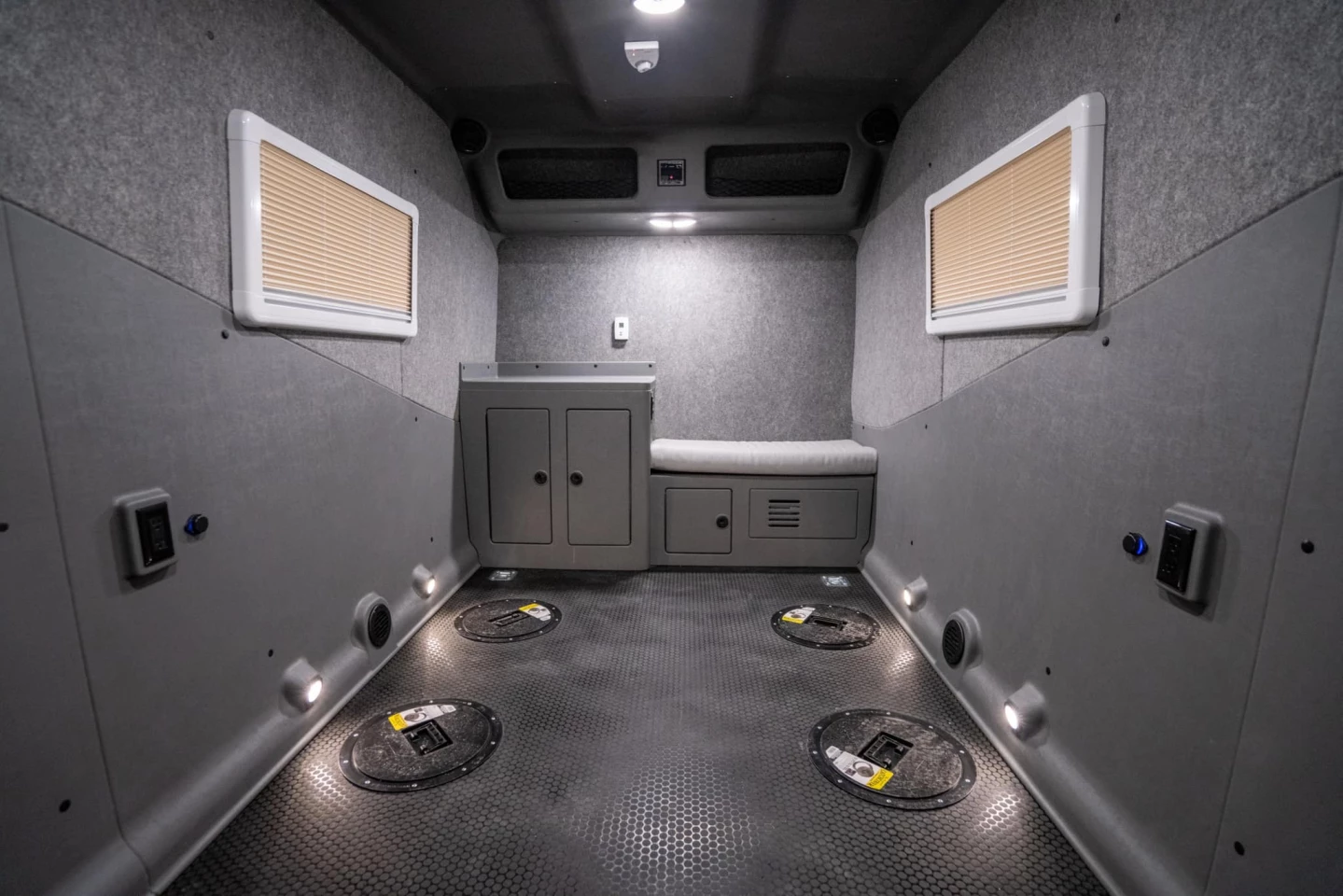 Inside, the IcePro trailer is a largely empty garage/fish hut with a bench to sit on, a countertop to work and store on, several cabinets, a stereo and, of course, several fishing holes with removable covers