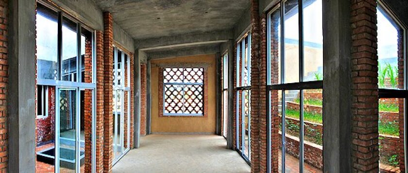 A view of the house's living room, with windows showing the washing courtyard to the left, and the garden courtyard to the right (Photo: John Lin)