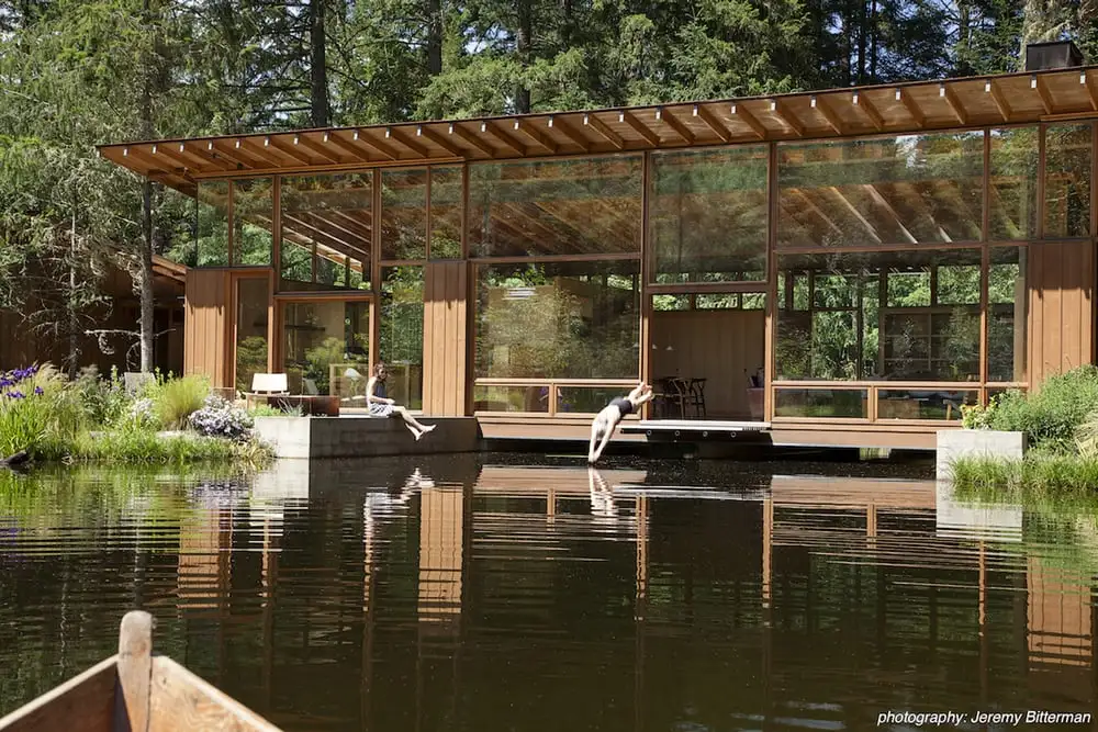 Cutler Anderson Architects' Newberg Residence is a luxury home that takes the form of a bridge over a large pond