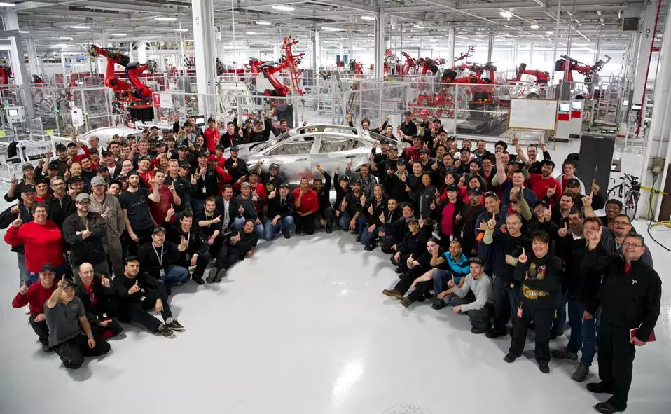 Tesla employees celebrate construction of the first customer Model S body