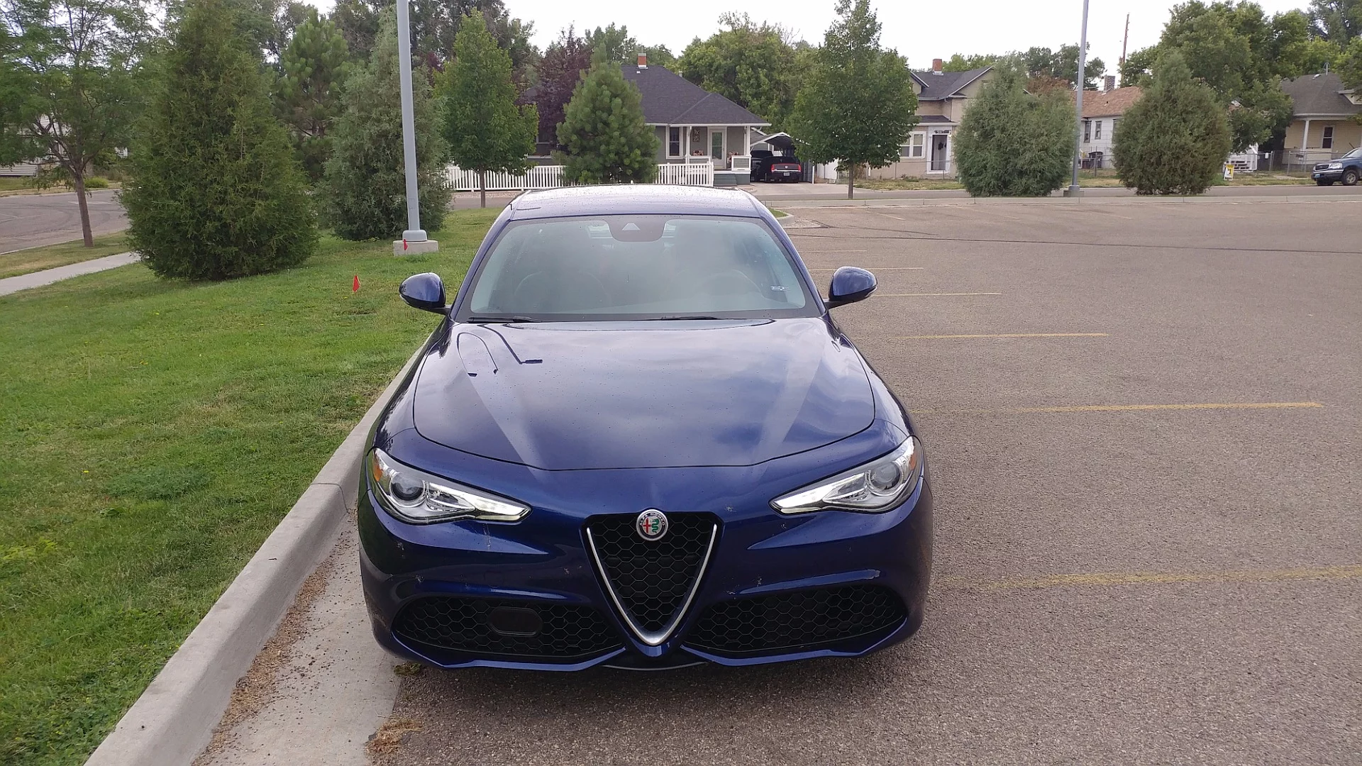 The front grille has the signature (and oft-copied) Alfa Romeo triangle flanked by thin-slitted headlamps and strong intakes beneath