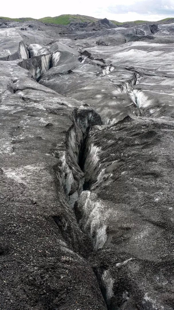 The glacier has a series of plummeting crevasses, caused when different parts of the flowing ice move at different speeds or hit large obstacles like boulders. It also has areas filled with "rotten ice," spots on the glacier where the ice has been exposed to sunlight and has weakened due to cracks. It forms a crumbly type of ice that would be useless when struck with an ice pick to stop a climber's fall into an unseen crevasse.