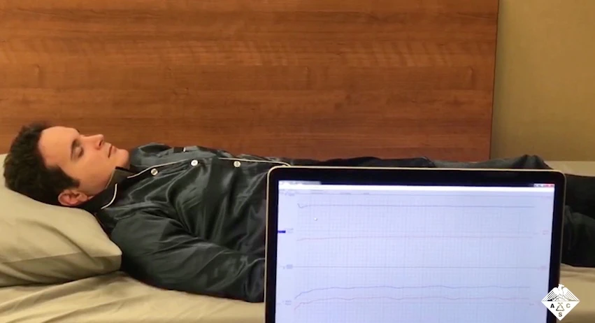 A volunteer helps test the Phyjama – their sleep data is visible on the computer screen