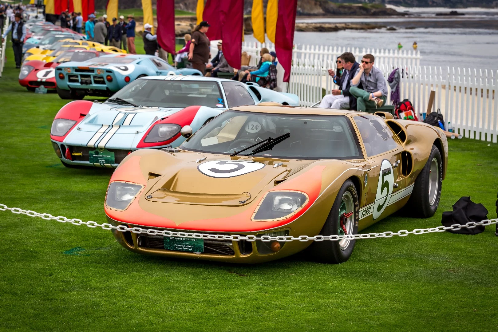 Bronze colored 1965 Ford GT40 starts off the row of legendary racers