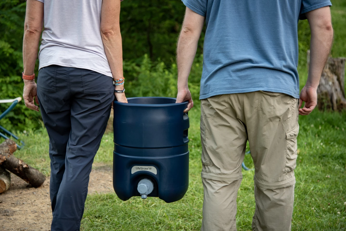 Water weighs roughly 8 1/3 lb per gallon, and the Escape itself weighs 16 lb, totaling over 59 lb - so carrying it in twos will help ease the burden