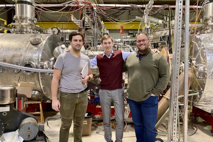 The new coating will be used in the WHAM device, seen here behind researchers Jeremiah Kirch, Mykola Ialovega, and Marcos Xavier Navarro-Gonzalez, from left to right