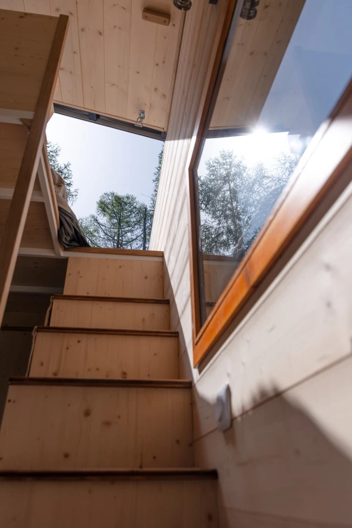 Storage-integrated staircase leads up to the Tiny House Franck's bedroom