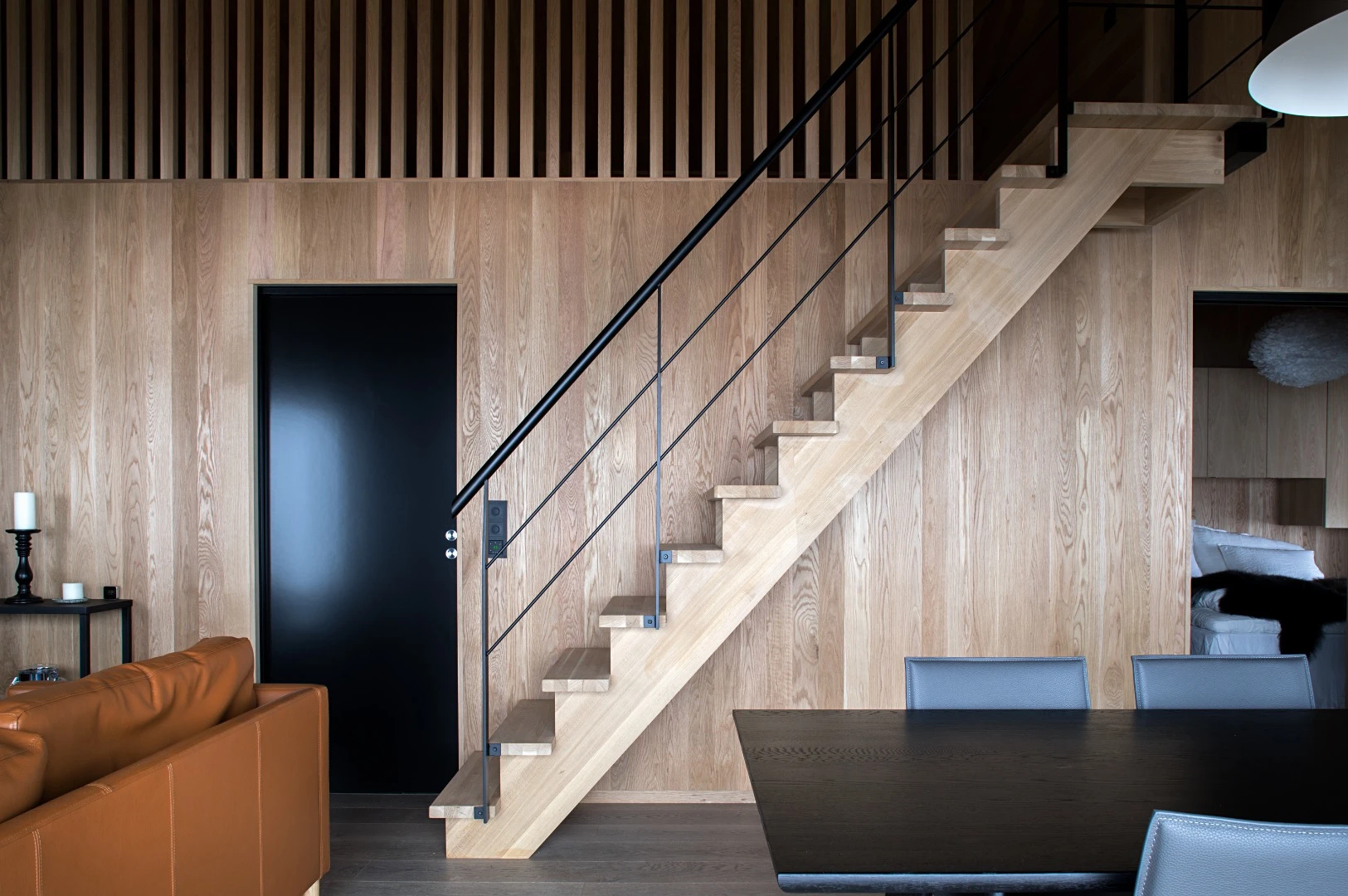 The Hooded Cabin's stairs in the living area lead up to an attic space that sleeps up to eight people