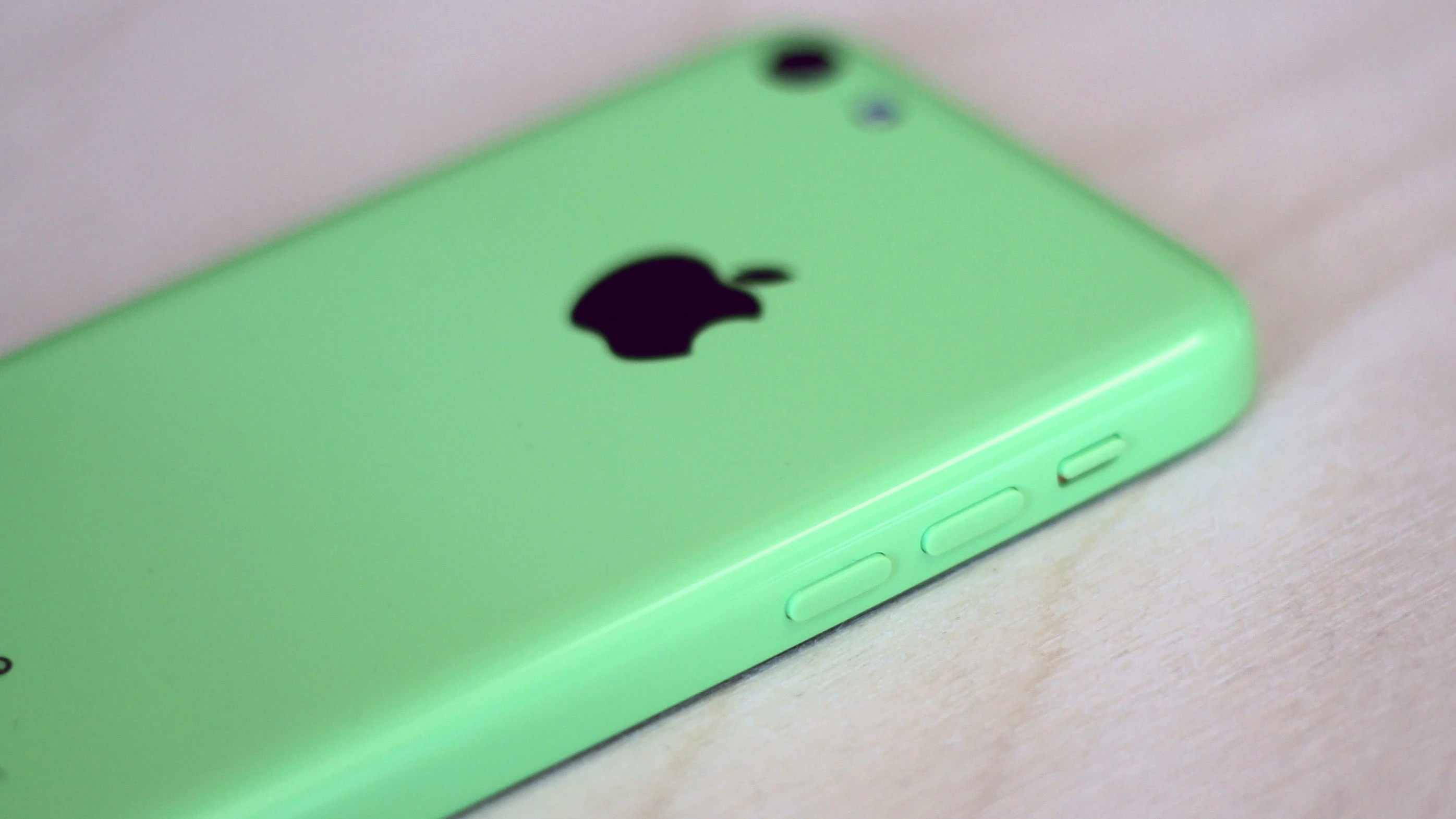 The iPhone 5c's polycarbonate body has sloped edges and a smooth, solid finish