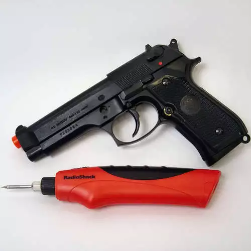 The HFC M9 Spring Airsoft Gun Pistol and RadioShack cordless soldering iron before being dismantled and merged into one