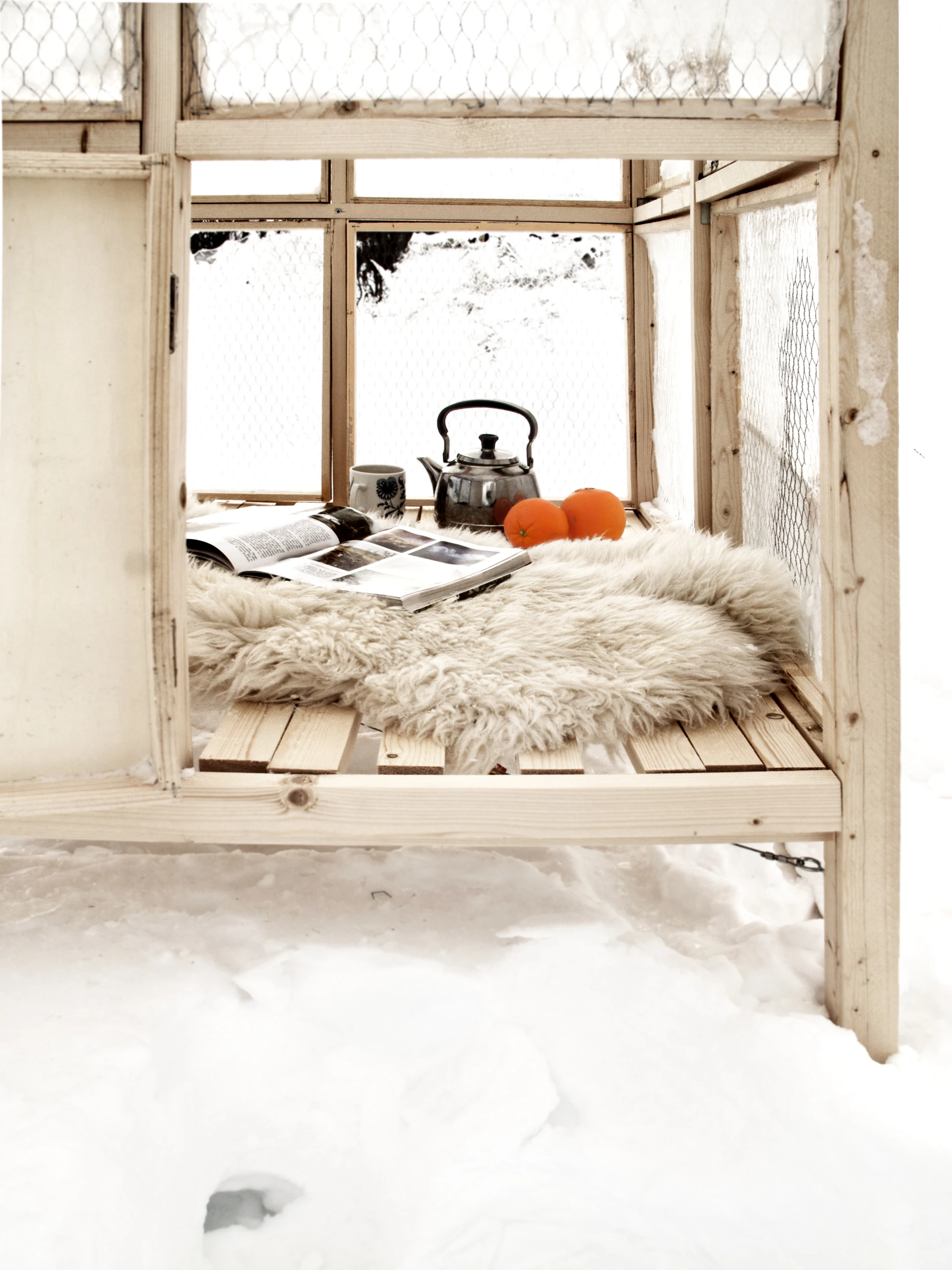 A single panel of the structure made from birch veneer functions as a door, and reveals a wooden-slatted base which, with the addition of a rug actually looks rather cosy