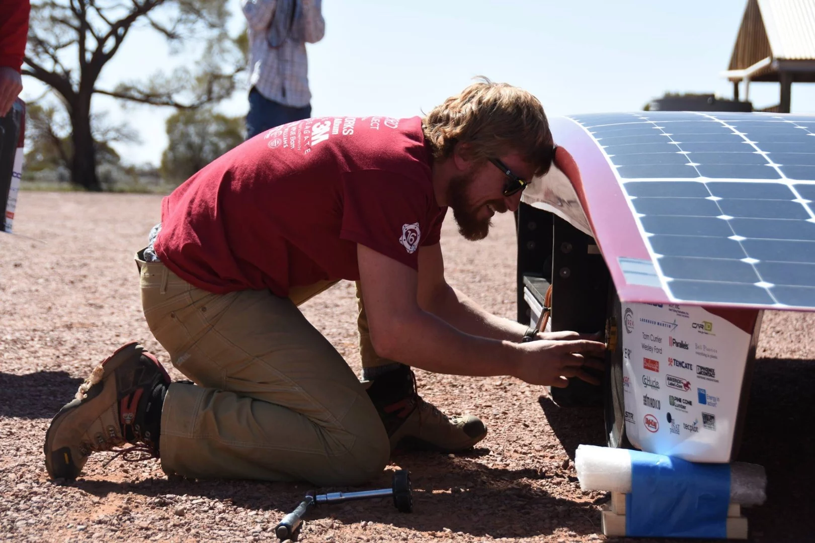 A Stanford University team member with the Arctan solar car ahead of the World Solar Challenge