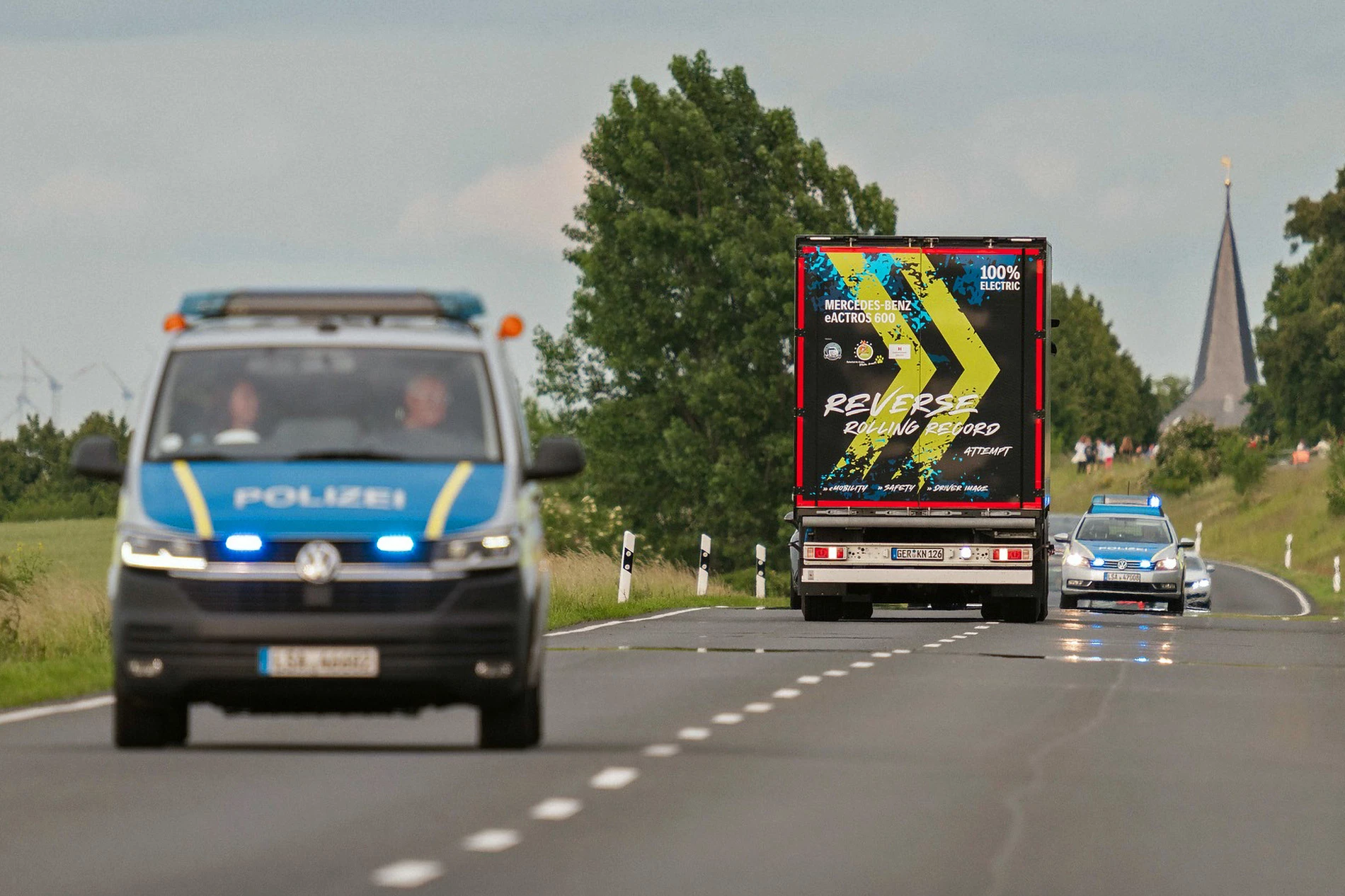The Mercedes-Benz eActros 600 truck catches a police escort as it zips between Oschersleben and Halberstadt in Germany ... backwards