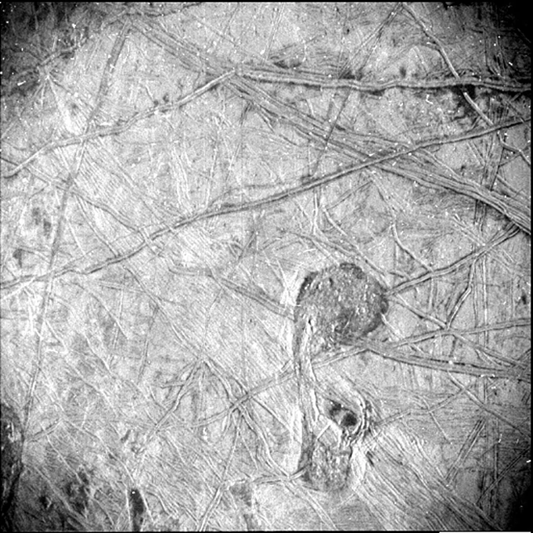 A close-up image of the Jupiter moon Europa reveals the surface at a resolution of 840 to 1,115 feet (256 to 340 meters) per pixel