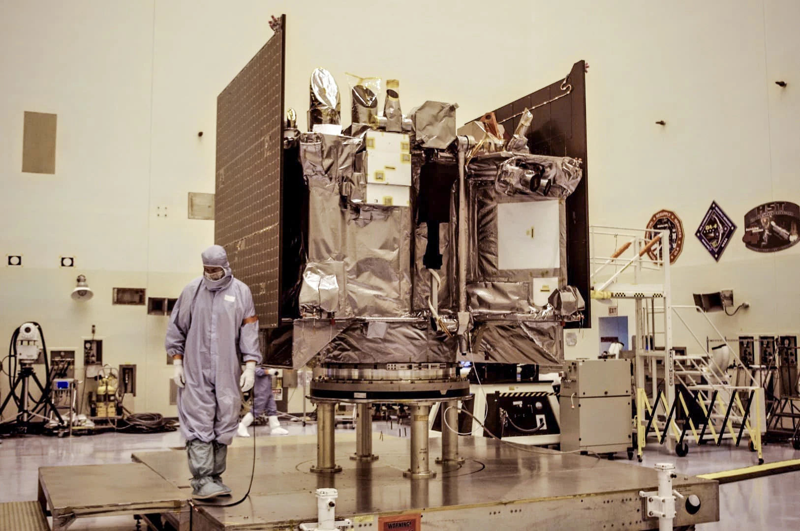 The black-wrapped portion of the satellite is its TAGSAM arm, which stands for touch-and-go sample acquisition mechanism