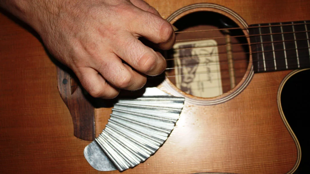 When attached below the picking area of an acoustic guitar, the Pik'N Board offers players the means to provide their own strum-stroke back beat