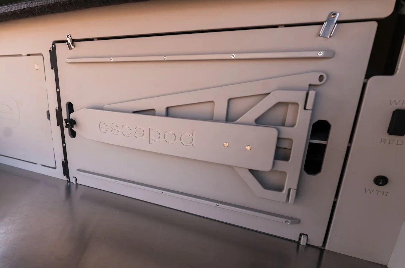 One of Escapod's more creative multipurpose features, the main galley cabinet door secures to the side of the trailer and becomes a table