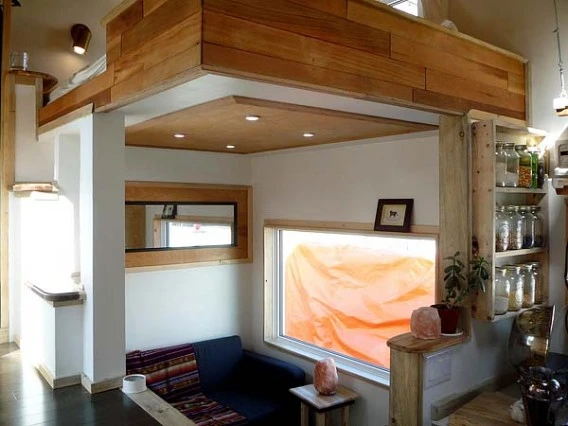 Living area with sofa bed and raised sleeping quarters