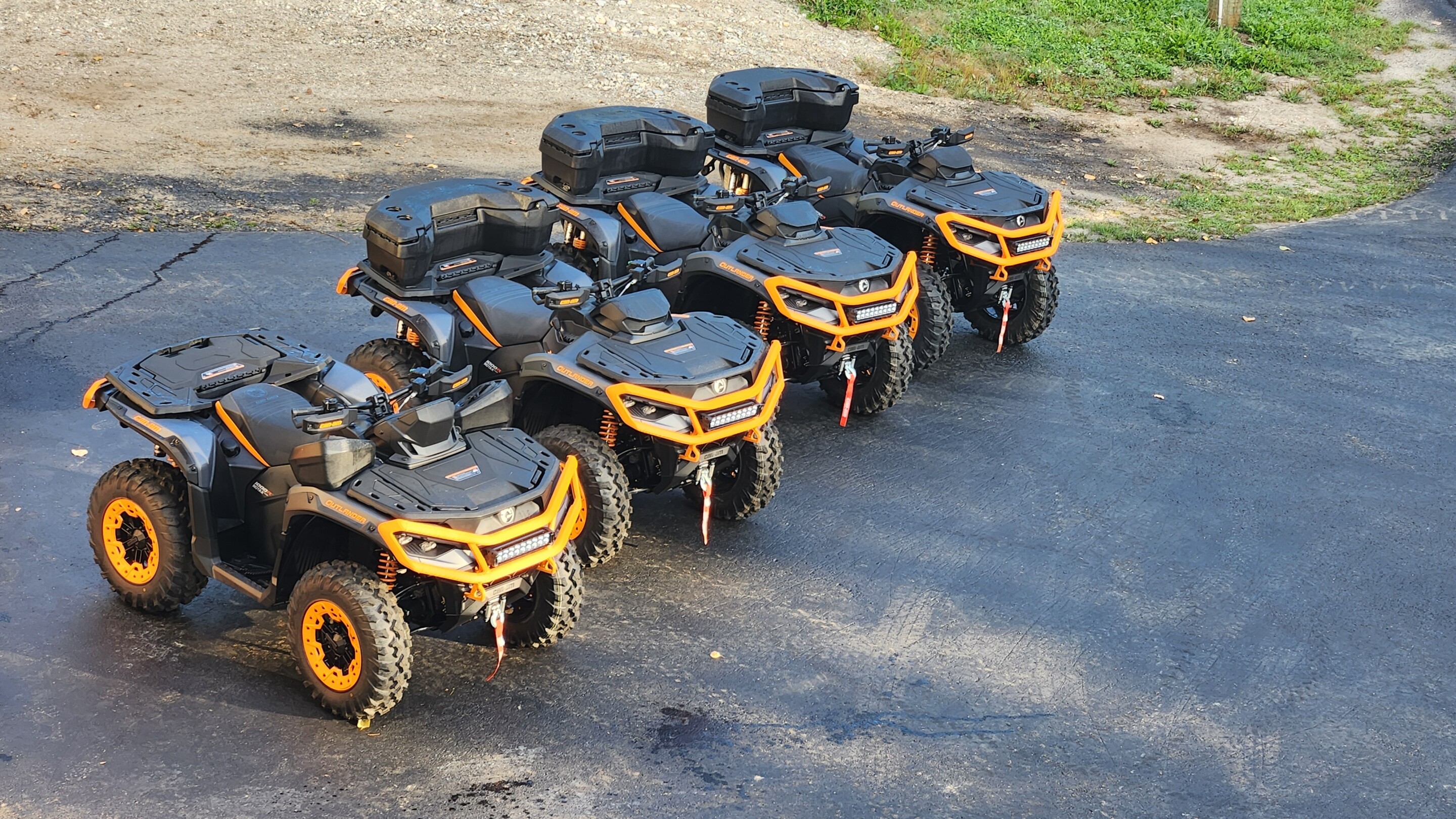 A lineup of 2025 Can-Am Outlander 1000Rs at "base camp" at a snowmobiling lodge in BC, Canada