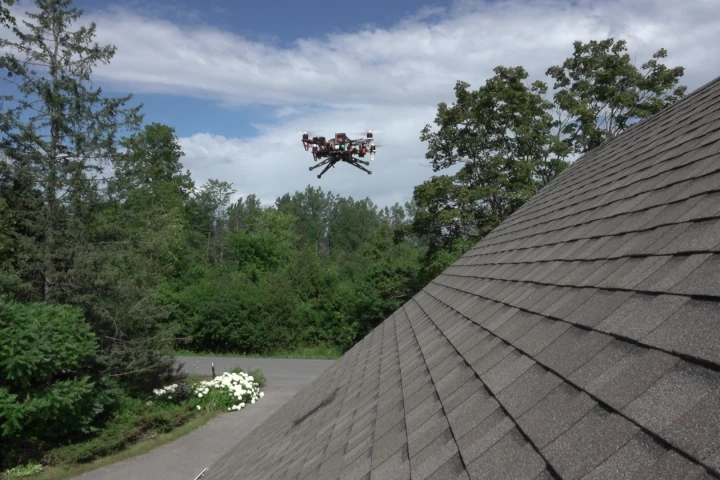 With specialized landing gear and rapid reverse thrust capabilities, a modified drone has the ability to land on rooftops with pitches of up to 60 degrees