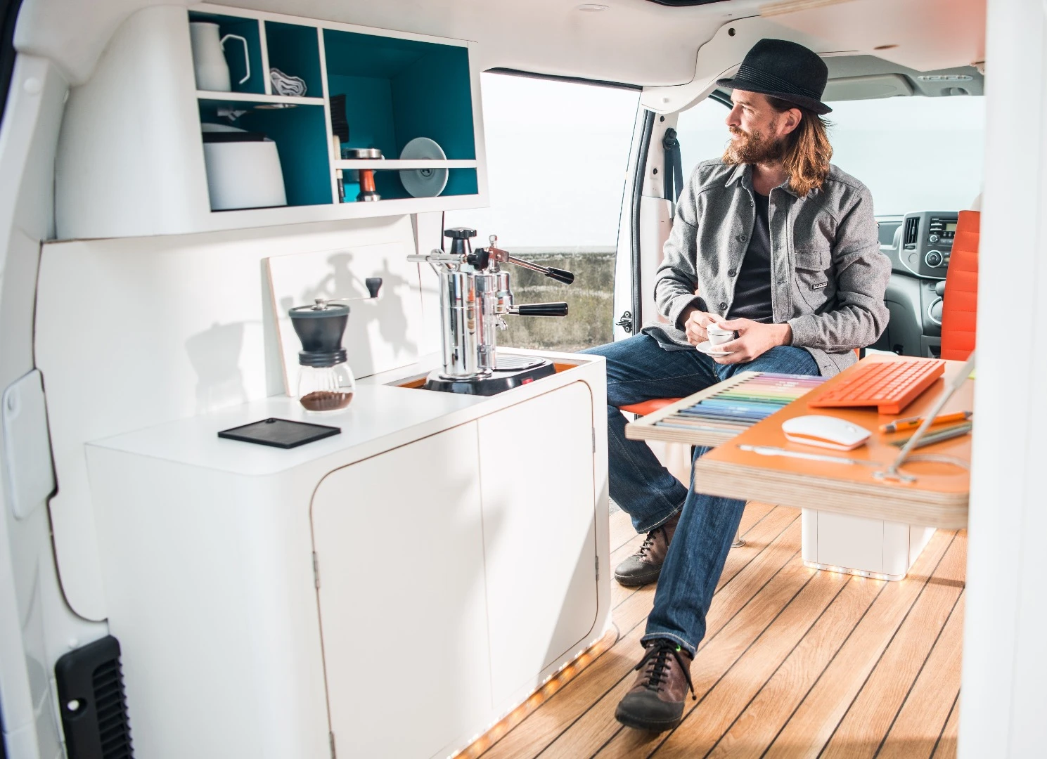 The interior includes an espresso maker and two desk chairs