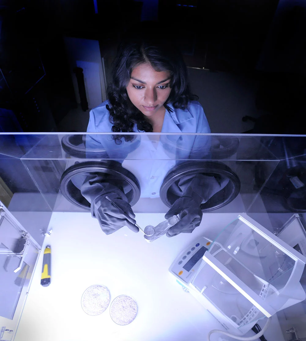 Goddard technologist Nithin Abraham analyzes a sample of gas-adsorbing paint (Photo: NASA/Pat Izzo)