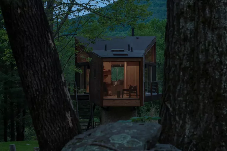 The treehouse includes a series large floor-to-ceiling glass windows and sky lights