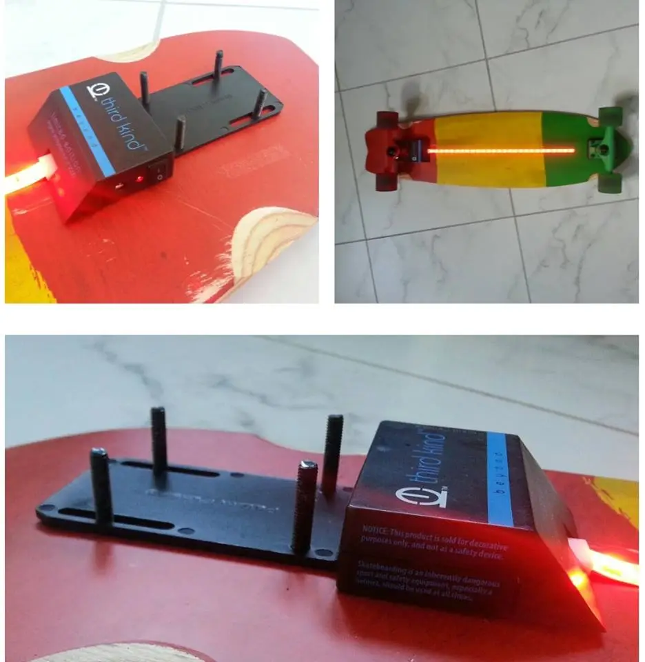 The battery pack mounts in front of the rear truck, and the light strip sticks to the deck