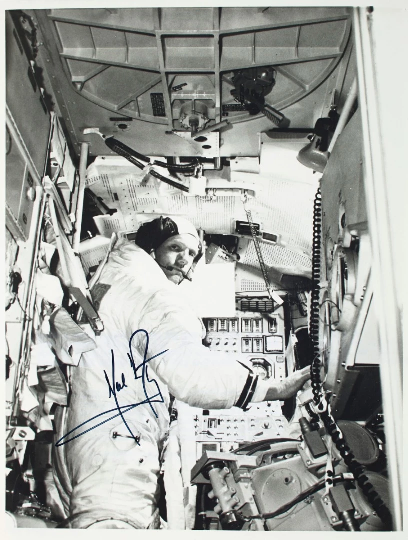A signed photograph of Commander Neil A. Armstrong aboard a lunar module simulator, taken about a month before the Apollo 11 mission, is also to be auctioned in the sale