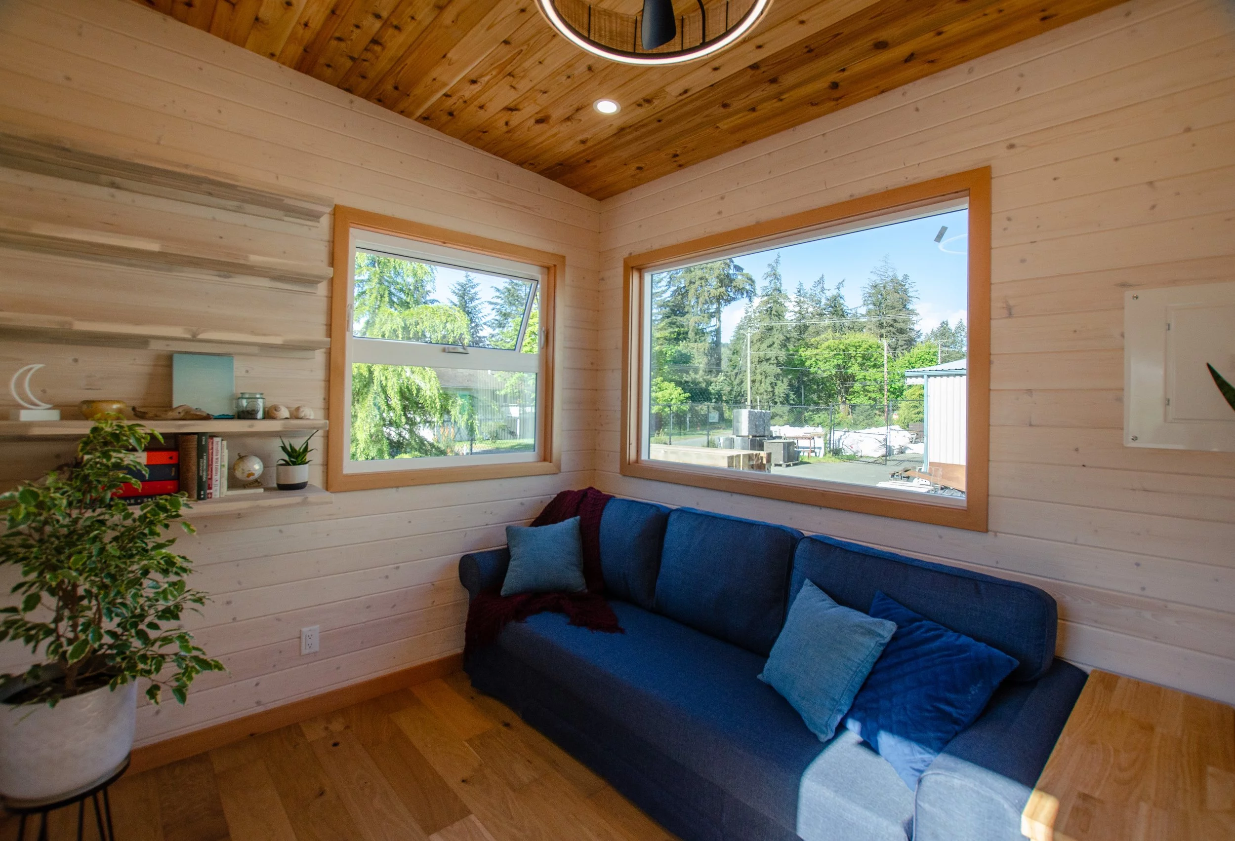 The Juniper's living room includes a large sofa and some shelving