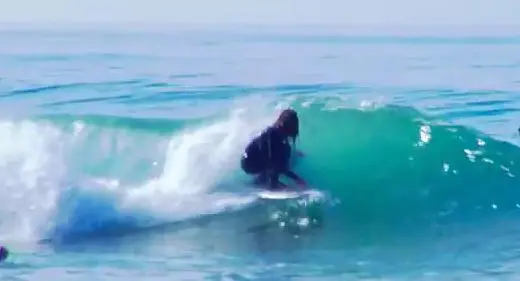 The snowboard bottom doesn't appear to hurt the surfing
