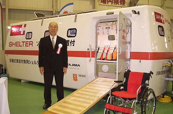 Nobuhiro Tajima the CEO of Tajima Motor Company standing in front of a 20 person version of the SAFE+ Shelter. The company participated in a Disaster Prevention Risk Management exhibition held on the 20th of April 2014 in Hamamatsu City, west of Tokyo.