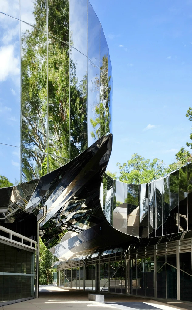 The Cairns Botanic Gardens Visitor Center reflects its surrounding botanical garden landscape