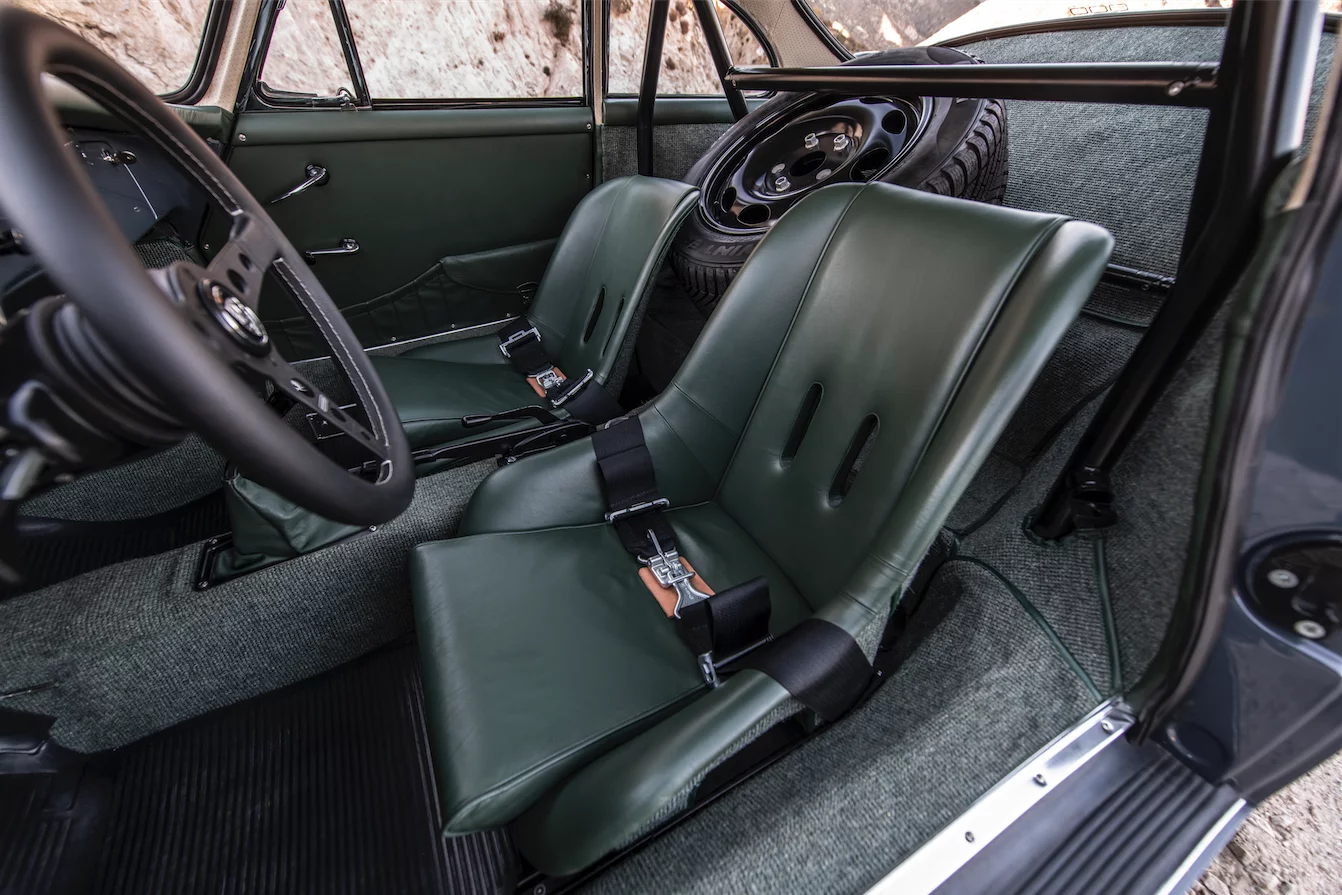 Individual seats, a roll cage and green carpeting create a distinctive interior