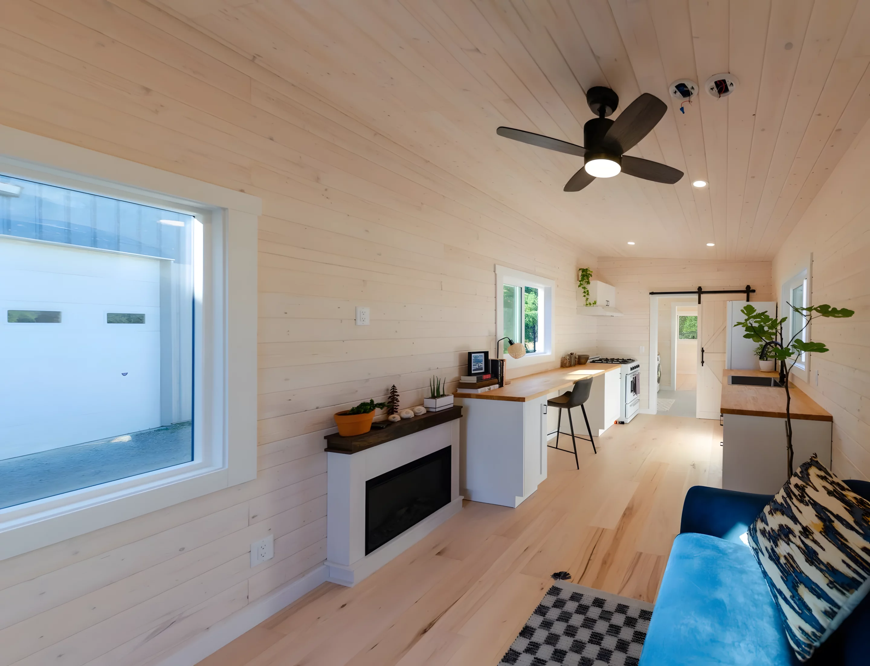 The Barred Owl offers a roomy interior that feels more like a small apartment than a typical tiny house