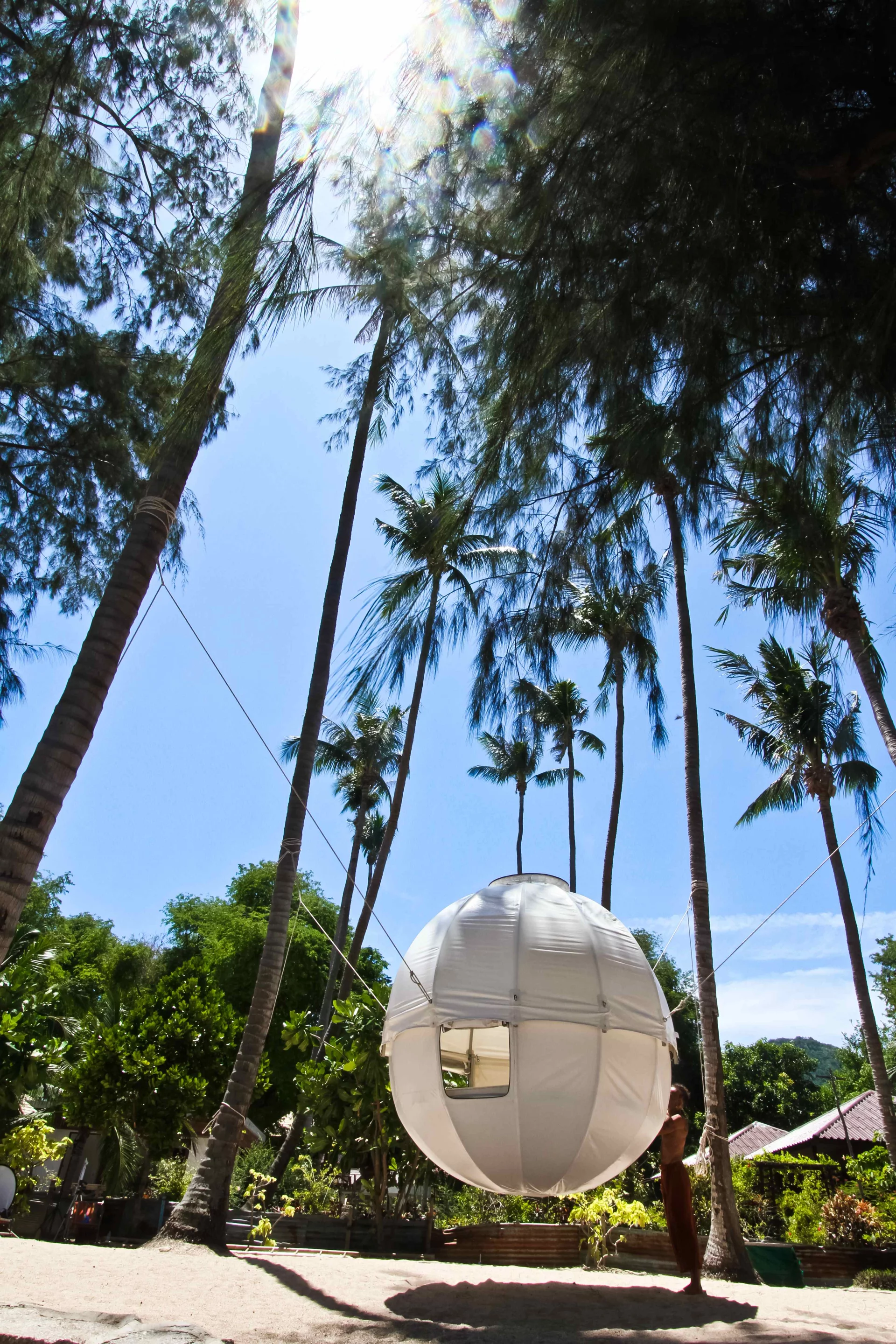 The Cocoon Tree features a spherical T6 aluminum frame covered with waterproofed white tarpaulin