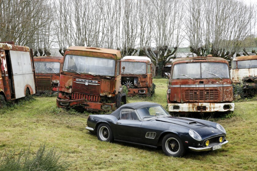 The Ferrari 250 GT California SWB Spider from the Baillon Collection sits among relics from Baillon's booming transport business of five decades ago © Artcurial