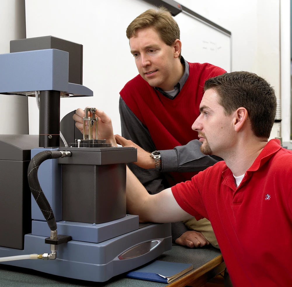 Michael Kessler (left) and former Iowa State doctoral student Will Goertzen use a dynamic mechanical analyzer to measure the mechanical properties of polymers (Photo: Michael Kessler)