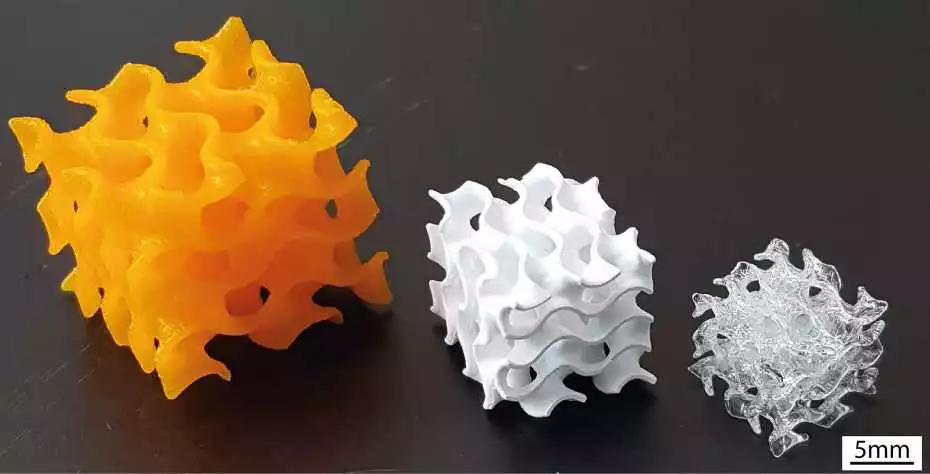 An initial polymer/ceramic structure (left) alongside the ceramic-only version (middle) and the final all-glass object