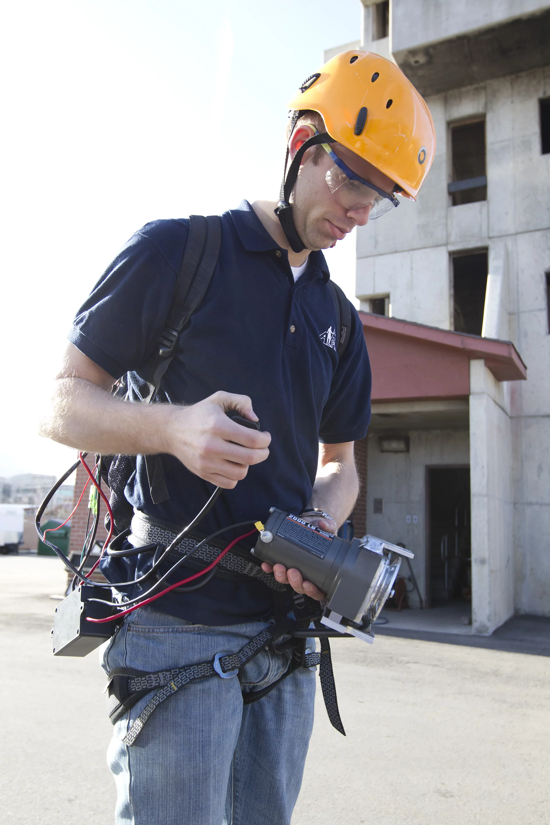 Engineering student Dave Monk shows off the motorized winch device and battery pack