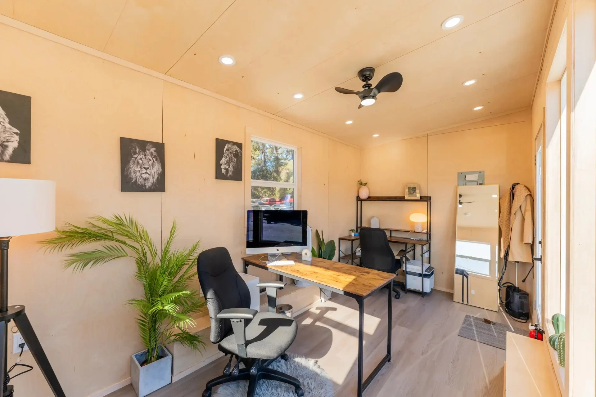 Though it would be very small for a house, the tiny office has ample space for multiple desks and a sofa